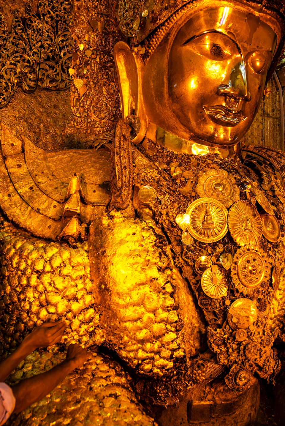 يلصق الناس أوراق الذهب على تمثال Mahamuni Buddha الذهبي ، Mahamuni Paya Pagoda ، Mandalay ، ميانمار ، آسيا