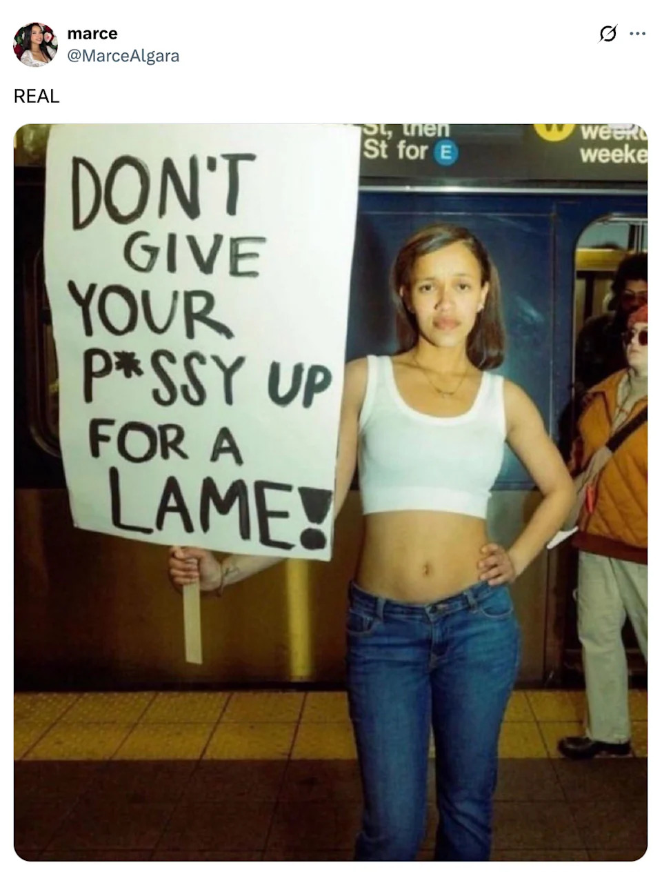 شخص في محطة مترو أنفاق يحمل علامة تقول ، "لا تعطي p*ssy لعرج!"