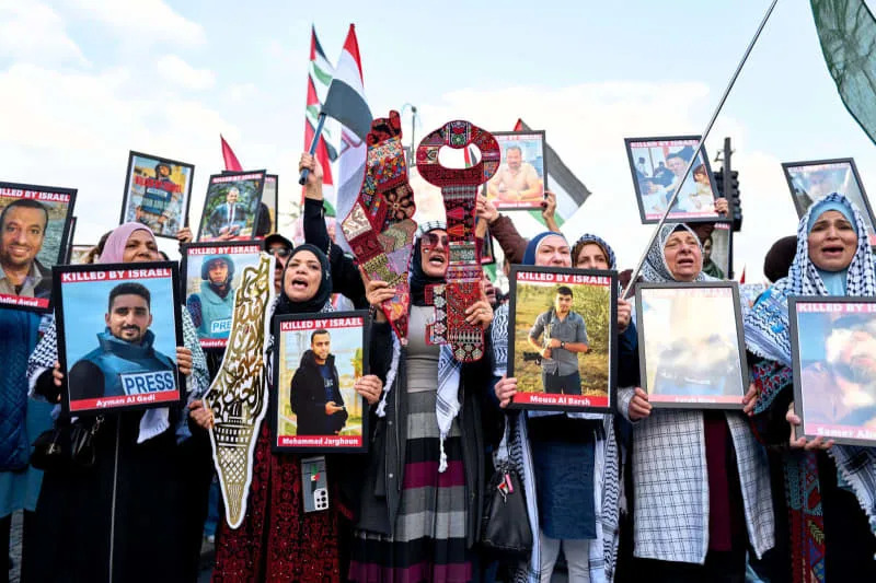 متظاهرون يلوحون بالأعلام الفلسطينية ويحملون ملصقات خلال المظاهرة "United4Gaza" التجمع عبر المنطقة الحكومية. مايكل أوكاس/ وكالة الأنباء الألمانية