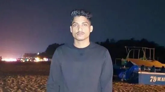 ساتيش رانا، من ولاية أوتارانتشال، يقف على الشاطئ ويرتدي بلوفر أسود بأكمام كاملة