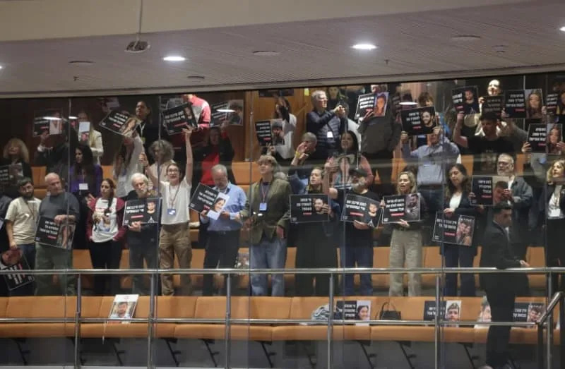 أعضاء الكنيست يرفعون لافتات تنتقد الحكومة، القدس، 24 ديسمبر 2025 (Credit: MARC ISRAEL SELLEM)