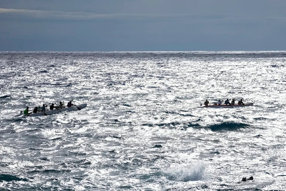 زورقان، يضم كل منهما عدة أفراد، على الماء